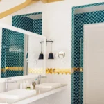 A modern bathroom featuring a large mirror, dual sinks, and decorative blue and gold tile accents, creating an elegant ambiance.