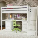 A stylish loft bed with a desk and a green chair beneath, set against a textured brick wall in a cozy room.
