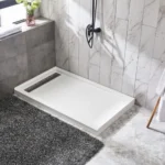 A modern bathroom featuring a sleek shower area with a white shower base, a gray rug, and a wooden towel rack holding a robe.